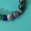 Create a stunning and spiritually inspired look with the Chakra Bracelet adorned with Hematite Beads, available at KJsKrystals, LLC, and let its grounding properties shine through your style.