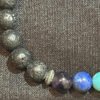 Discover the unique design of the Chakra Bracelet with Lava Beads and Gears for Spacers from KJsKrystals, LLC, and let the combination of chakras and lava stones enhance your accessories.