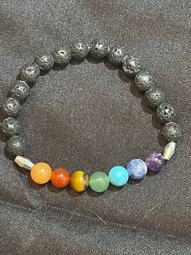 Create a stunning and spiritually inspired look with the Chakra Bracelet adorned with Lava Beads and Barrel Spacers, available at KJsKrystals, LLC, and let its grounding properties and unique design enhance your style.