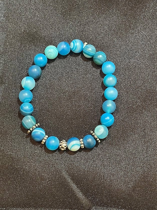 Embrace the beauty and tranquility of the Matte Blue Agate Bracelet with Spinner Spacers from KJsKrystals, LLC, and add a touch of spiritual enlightenment to your gemstone collection.