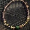 Elevate your style with the Amethyst Bracelet featuring a Malachite Bead from KJsKrystals, LLC, a captivating and spiritually enhancing gemstone accessory.